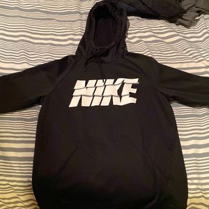Plain black nike hoodie with white nike symbol in the middle